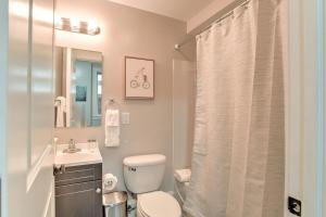 a bathroom with a toilet and a sink and a shower at Historic King James Unit 5 in Asheville