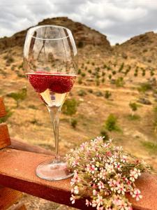 a glass of wine sitting on top of a table at Caravanà Resort in Yeghegnadzor +89 photos
