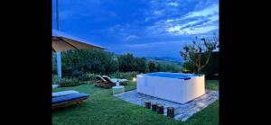 a large white tub sitting on top of a lawn at MiaClara Relais in Alba