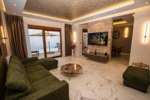 a living room with a couch and a fireplace at Villa Infinity in Sutomore