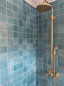 a blue tiled bathroom with a shower with blue tiles at *•*•Nouveau*•*• Chez Mirabelle in Belleville-sur-Meuse