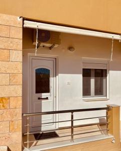 a front door of a building with a balcony at Sofi's Home Project in Sitia