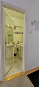 a bathroom with a sink and a washing machine at 3 min. away in Koprivnica