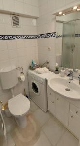 a bathroom with a washing machine and a sink at 3 min. away in Koprivnica