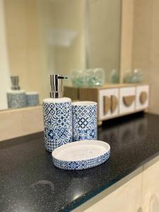 a bathroom counter with two blue and white cups on it at Stylish 2 Bed/Bath Apartment in Birmingham