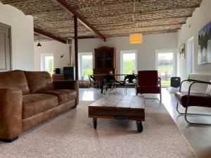 a living room with a couch and a table at Hof Gensterbloem 