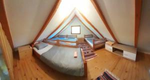 a attic bedroom with a bed in a house at Pure Nature in Bihać