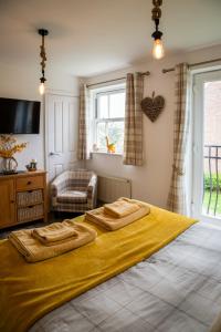 a bedroom with a large bed with two towels on it at Sandy Bottom in Filey