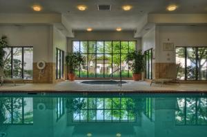 an indoor pool with plants in a building at Courtyard by Marriott Eugene Springfield in Springfield