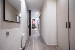 a hallway with white walls and wood floors at Tendency Apartments 9 in Barcelona