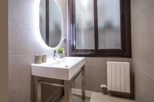 a bathroom with a white sink and a mirror at Tendency Apartments 9 in Barcelona
