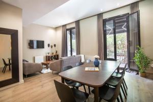 a living room with a wooden table and a dining room at Tendency Apartments 9 in Barcelona