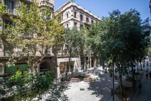 ulica w mieście z drzewami i budynkami w obiekcie Tendency Apartments 9 w Barcelonie