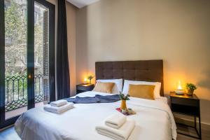 a bedroom with a large bed with towels on it at Tendency Apartments 9 in Barcelona +84 photos