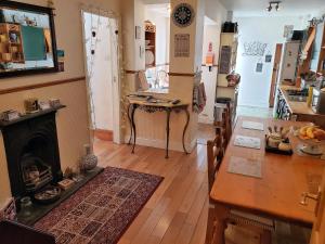 a living room with a table and a fireplace at Weaver's House B and B in Cardiff