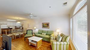 a living room with a couch and a table at Pawleys Island Fairway Haven 3BR Villa in Pawleys Island