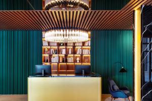 a lobby with green walls and a chandelier at Radisson Collection Hotel, Magdalena Plaza Sevilla in Seville