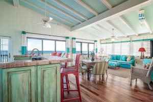 a kitchen and living room with a view of the ocean at Done Diggin An Oceanfront Oasis in Pawleys Island