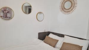 a bedroom with two mirrors and a bed with pillows at Stylish Quiet and Central in Rechovot