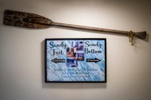 a baseball bat hanging on a wall with a picture at Sandy Bottom in Filey