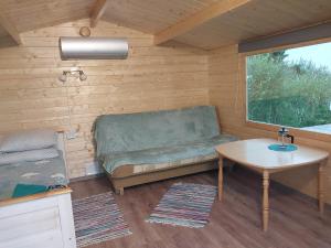 a small room with a couch and a table at Treimani Meremaja in Treimani