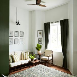 a living room with a couch and a window at Motu Bangkok in Bangkok