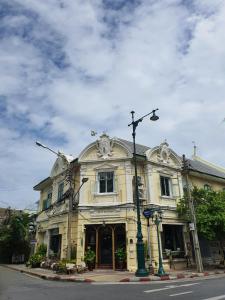 a yellow building with a street light in front of it at Motu Bangkok in Bangkok