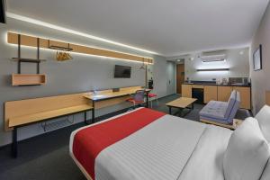 a hotel room with a bed and a desk at City Express by Marriott CDMX Plaza Central in Mexico City