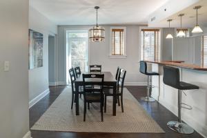 a dining room and kitchen with a table and chairs at 8 Village Lane 201 in Asheville