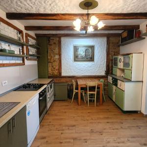 a kitchen with a table and a dining room at Banja Luka house - Casa Rustica in Banja Luka