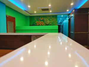 a white counter in a room with a green wall at Namaste Benares Varanasi in Varanasi