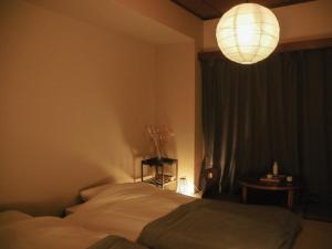 a bedroom with a bed and a chandelier at Sun Mall Crest 202 - Vacation STAY 15094 in Tokyo