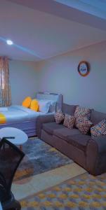 a living room with a couch and a table at Kathy's Place in Runda in Nairobi