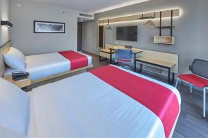 Postel nebo postele na pokoji v ubytování City Express by Marriott Comitán