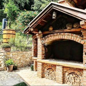 an outdoor brick oven with a stone wall at Banja Luka house - Casa Rustica in Banja Luka
