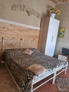 a bed in a room with a cheetah print bedspread at SPELTAUR B&B in Spoltore