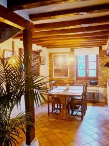 a dining room with a wooden table and chairs at Maison Marcks Champagne in Ay