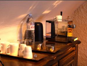 a counter with a coffee maker and cups on it at Maison Marcks Champagne in Ay