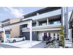 a white car parked in front of a building at Kyoto Four Sisters Residence - Vacation STAY 15222v in Kyoto