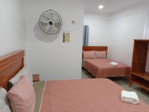 Postel nebo postele na pokoji v ubytování Orquídeas Hotel