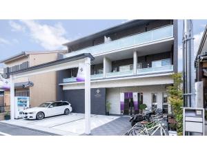 a white car parked in front of a building at Kyoto Four Sisters Residence - Vacation STAY 15215v in Kyoto