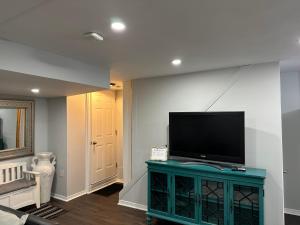 a living room with a flat screen tv on a wall at Luxurious and modern one bedroom basement suite. in Brampton