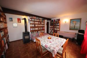 a room with a table and chairs and bookshelves at Albergo Diffuso Costauta in Costalta