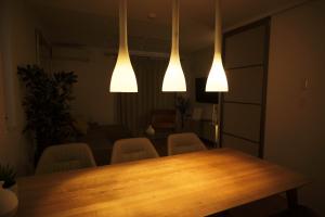 a room with a table and chairs and lights at Seirai Vacation Rental Hatsudai - Vacation STAY 15951v in Tokyo