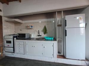 a kitchen with white appliances and a refrigerator at Mendoza Urbano Confort in Mendoza