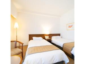 Tempat tidur dalam kamar di Hotel Terrace The Square Hitachi - Vacation STAY 17029v
