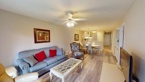 a living room with a couch and a dining room at Scenic Serenity 2BR Villa with Private Balconies in Pawleys Island