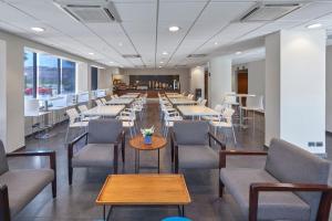 a long dining room with tables and chairs at City Express by Marriott La Paz in La Paz