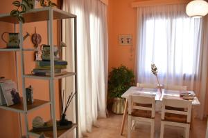 a dining room with a table and chairs and a window at ΆLthea Apartment in Chalkida
