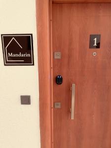 een houten deur met een bord erop bij AQUA Suite Kemer in Kemer